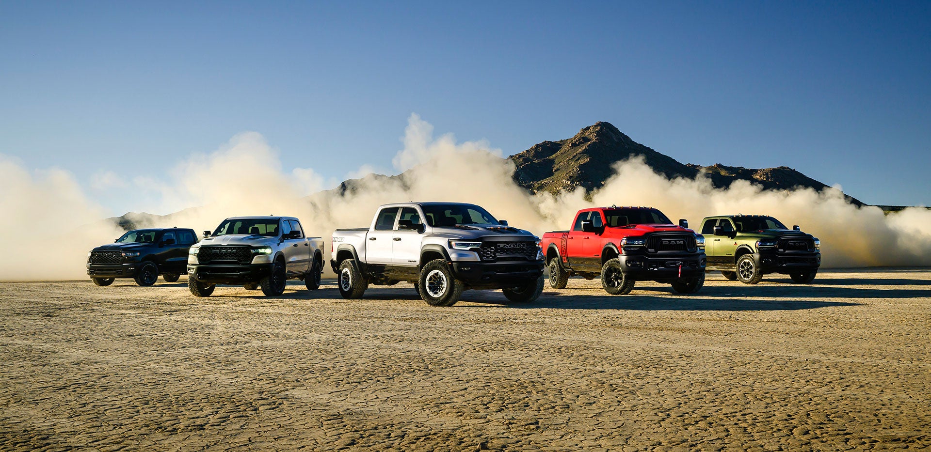 Powerful RAM trucks lineup on rugged desert terrain